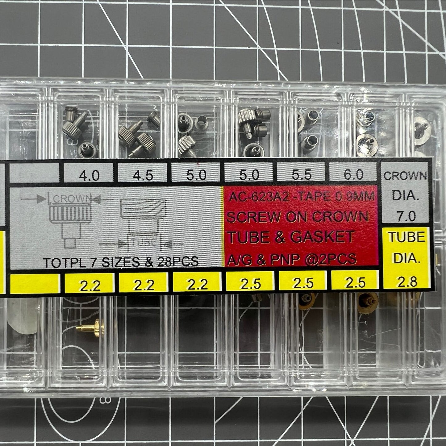Stainless steel watch crown with silver and gold tones, screw-on tube, and gasket for a secure fit.