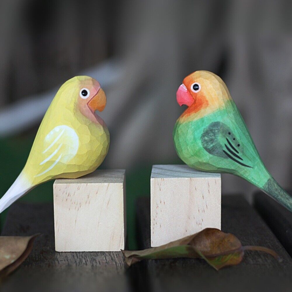 Handcrafted green and yellow wooden Agapornis Fischeri figurine, perfect decorative bird sculpture.