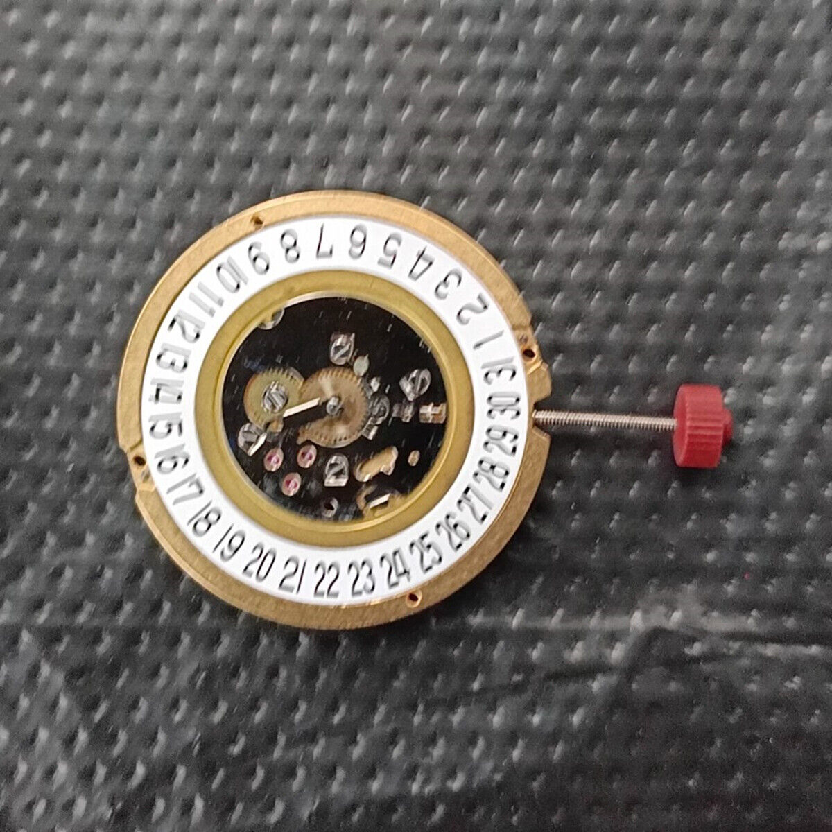 Ronda 1016 Swiss quartz watch movement with date display at 6 o'clock position.