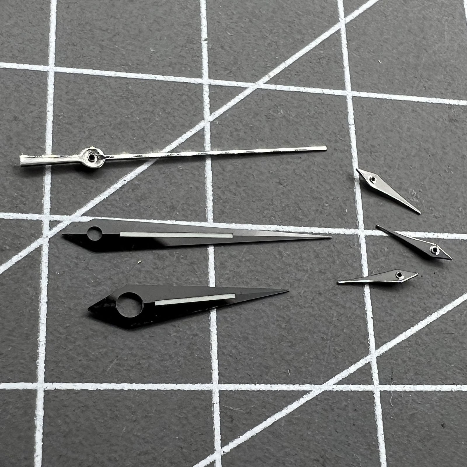 Polished black luminous watch hands set for Ronda 5040B, improving readability in low light,.