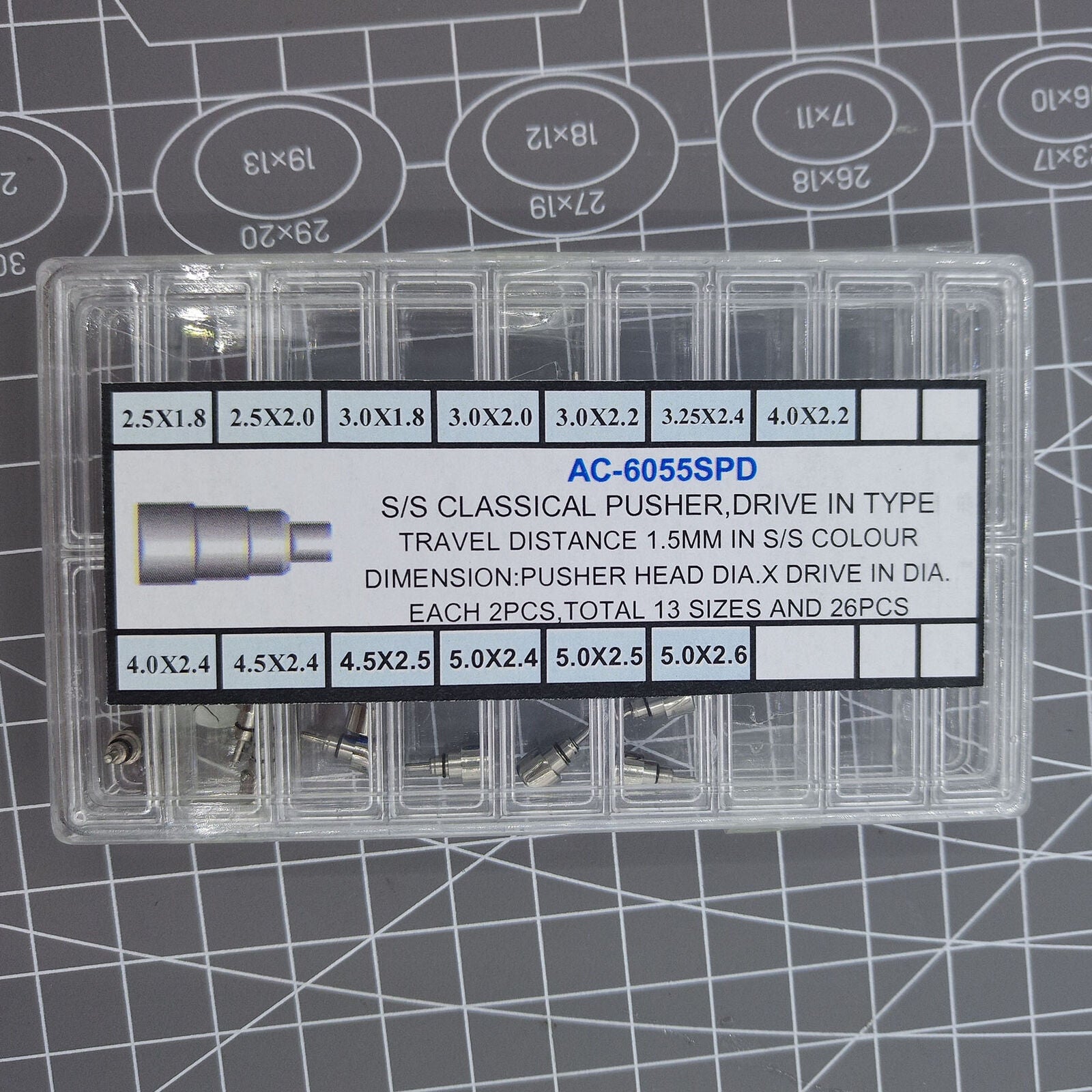 Classic stainless steel chronograph button set with 26 screw-in pushers for watch repair and customization.