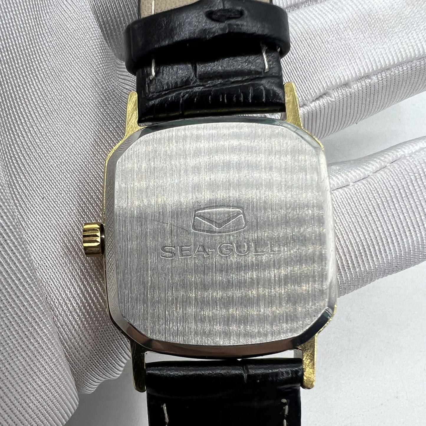 Seagull 28mm ladies watch with golden square case, manual movement, elegant gold nail markers.