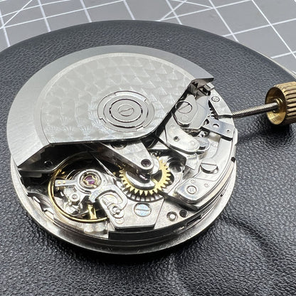 Dandong 7751 automatic watch movement displaying 8 hands with multifunctional time features for precision.