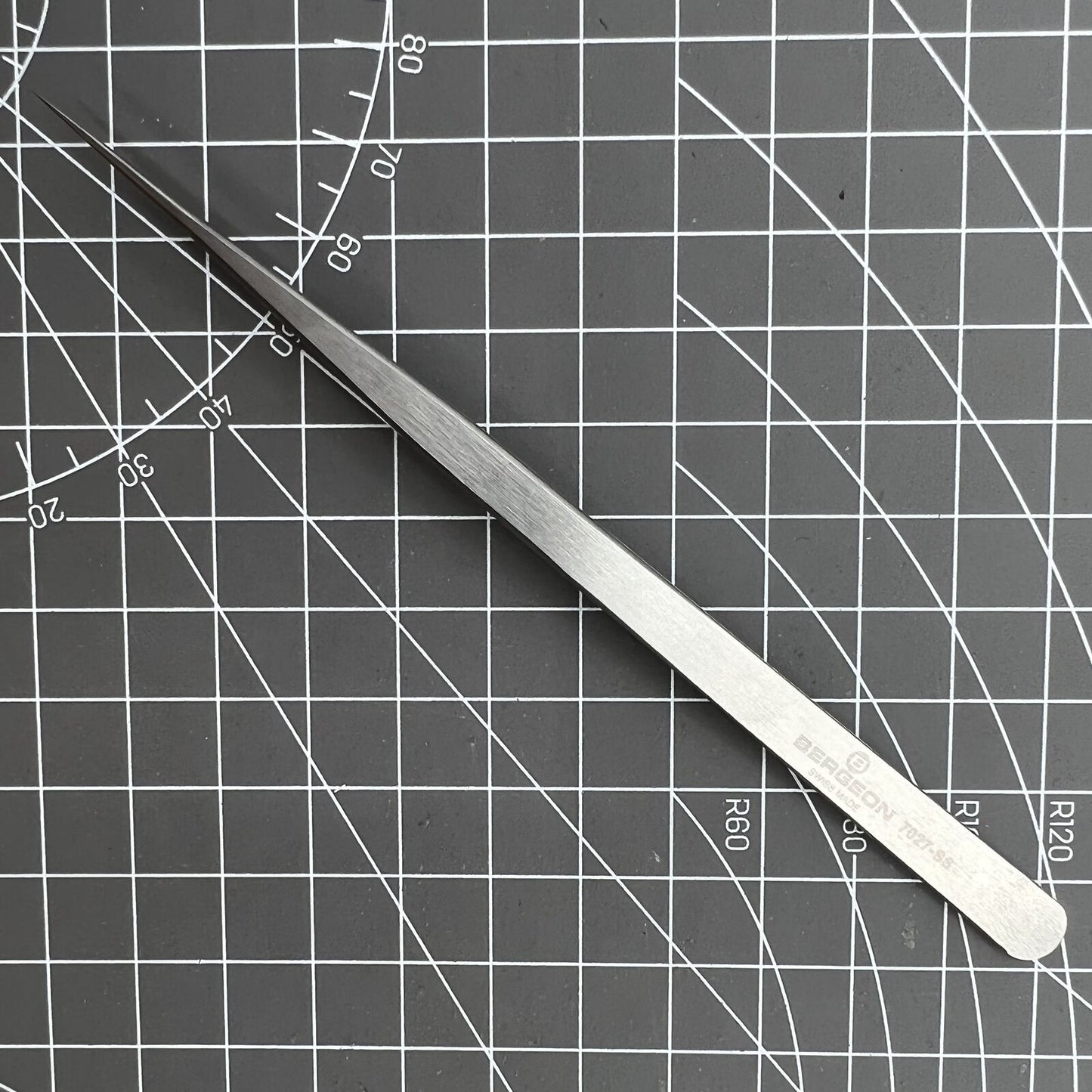 Swiss Made Bergeon 7027-SS tweezer with narrow, fine stainless steel tips for precise watch repair tasks.