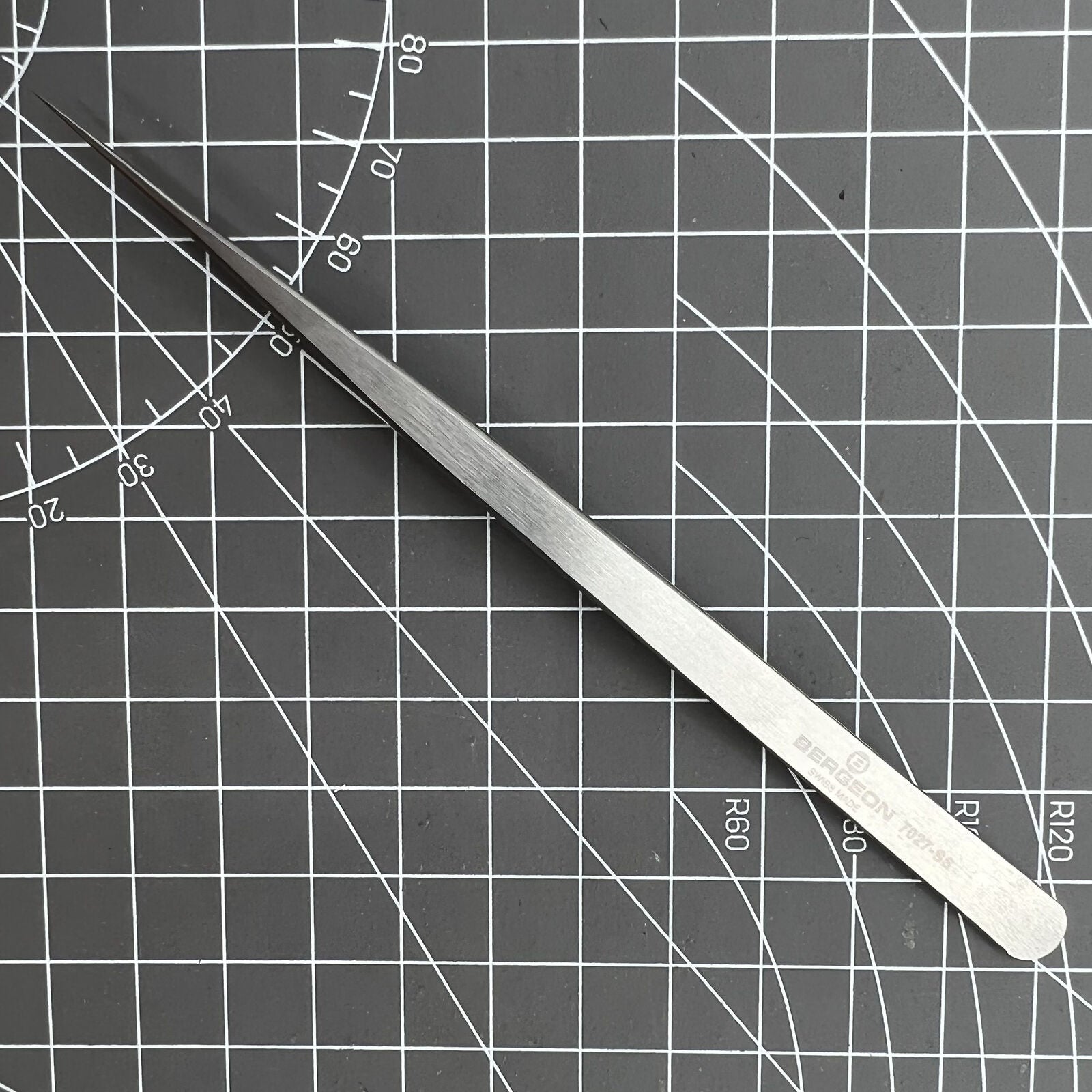 Swiss Made Bergeon 7027-SS tweezer with narrow, fine stainless steel tips for precise watch repair tasks.