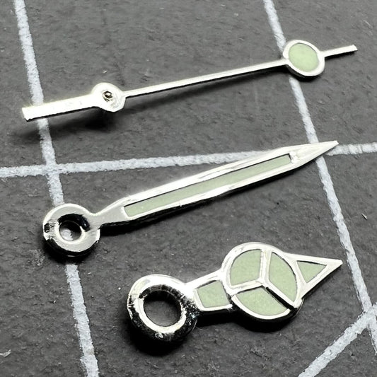 Silver trim green lume watch hands set for Miyota 2035 movement, enhancing visibility and style.