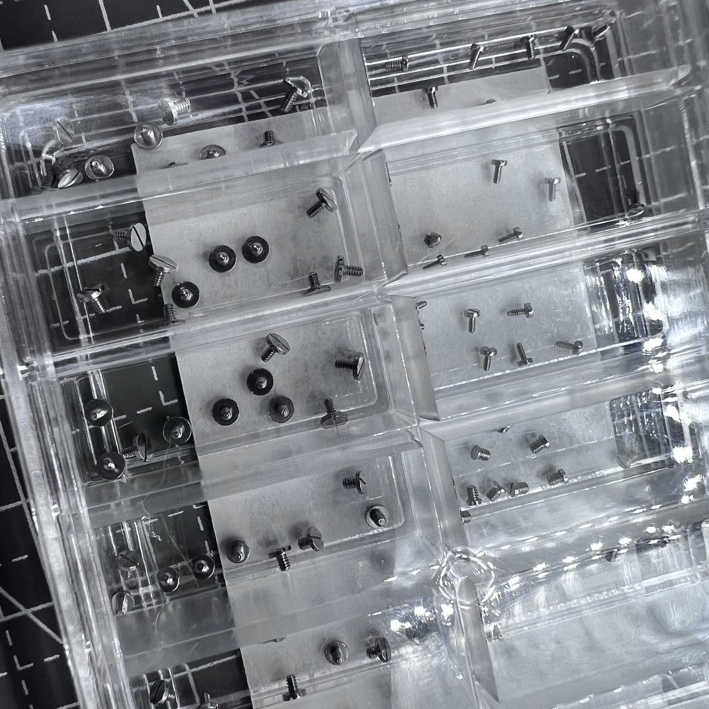 Set of 180 stainless steel mini screws for watch case backs, straight line head.