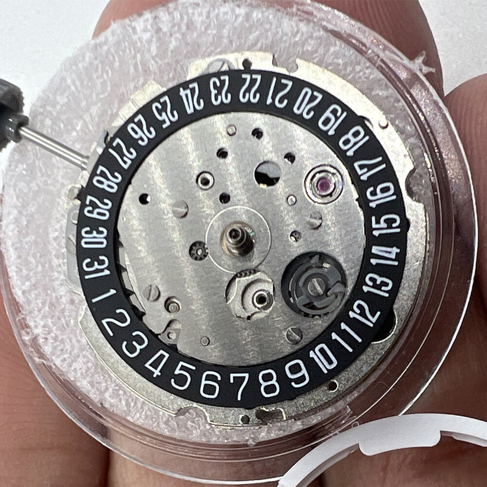 Miyota/Citizen 8215 automatic watch movement with black dial and date at 6 o'clock, Japan made.