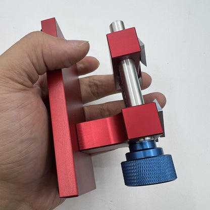 Professional watch bezel remover and case back opener tool for precise watch repair workbench.