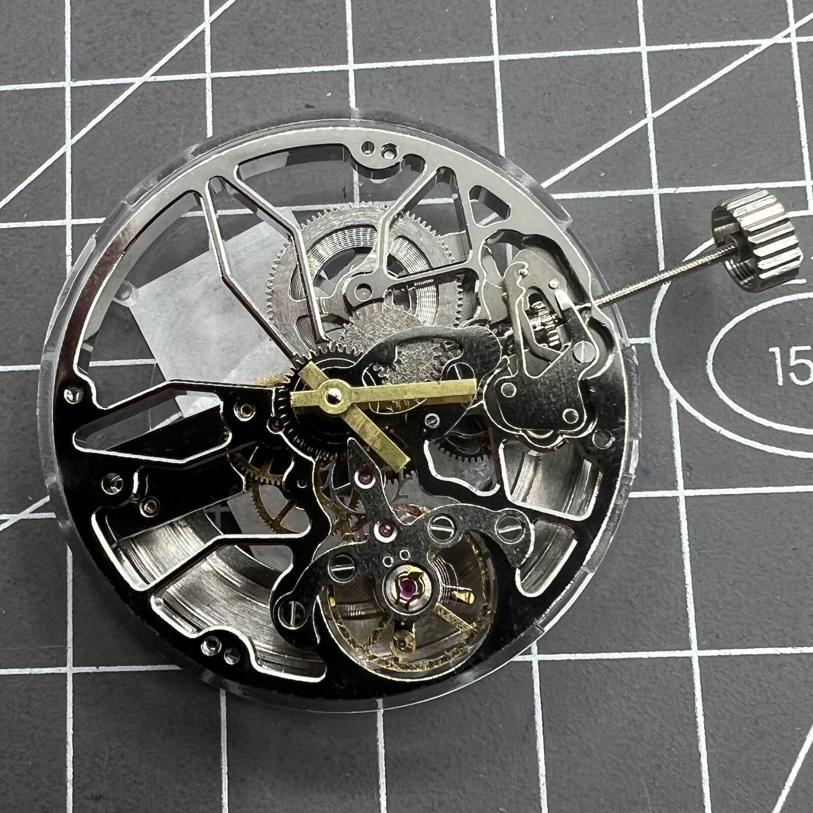 Dandong 8306 silver watch with hollow dial and 2-hand automatic mechanical movement, elegant design.