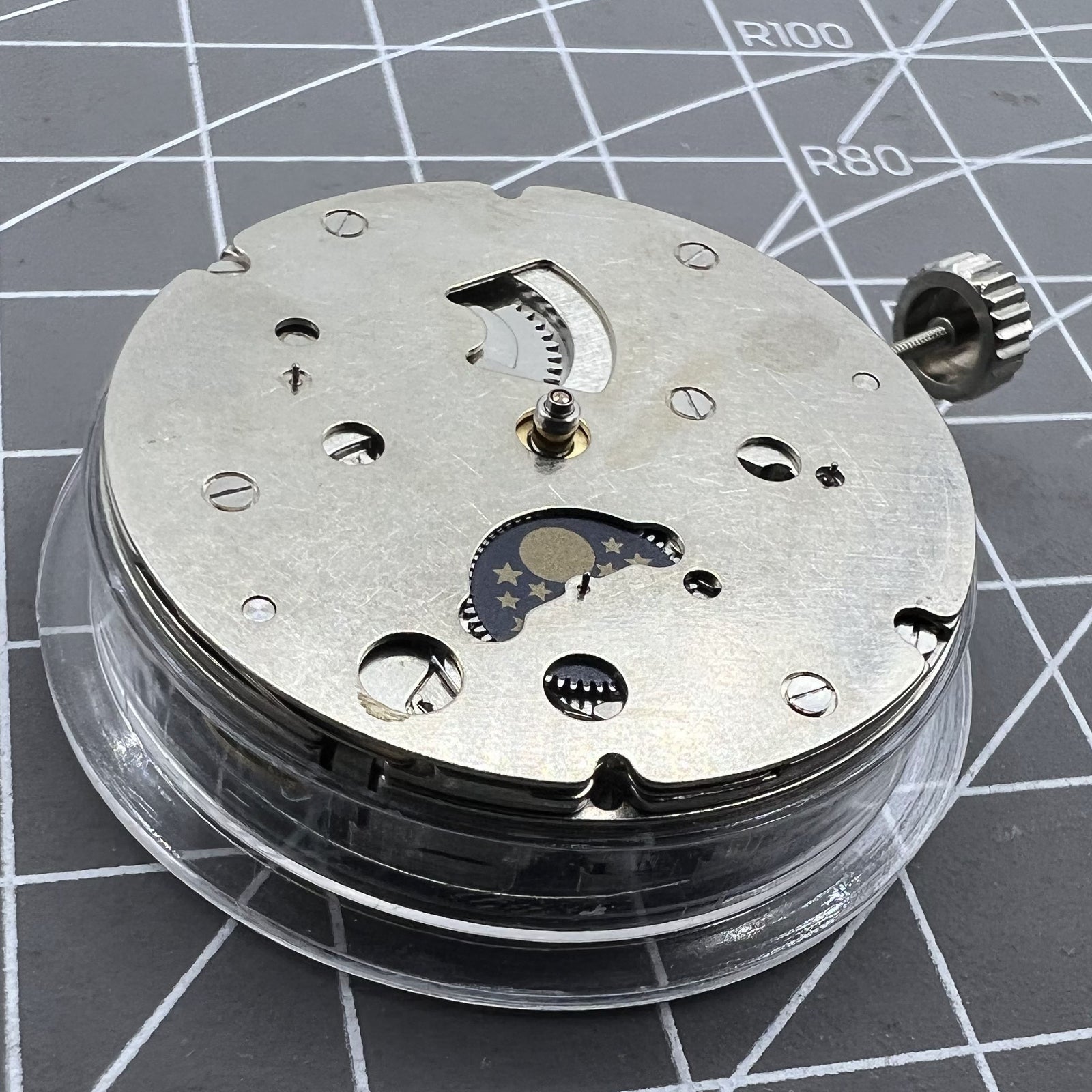 Close-up of China Made Hangzhou automatic kinetic watch with small second at 4 and no rotor, showcasing precise movement.