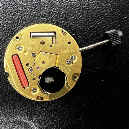 ETA F04.111 quartz watch movement with three hands and date, showcasing Swiss precision craftsmanship.
