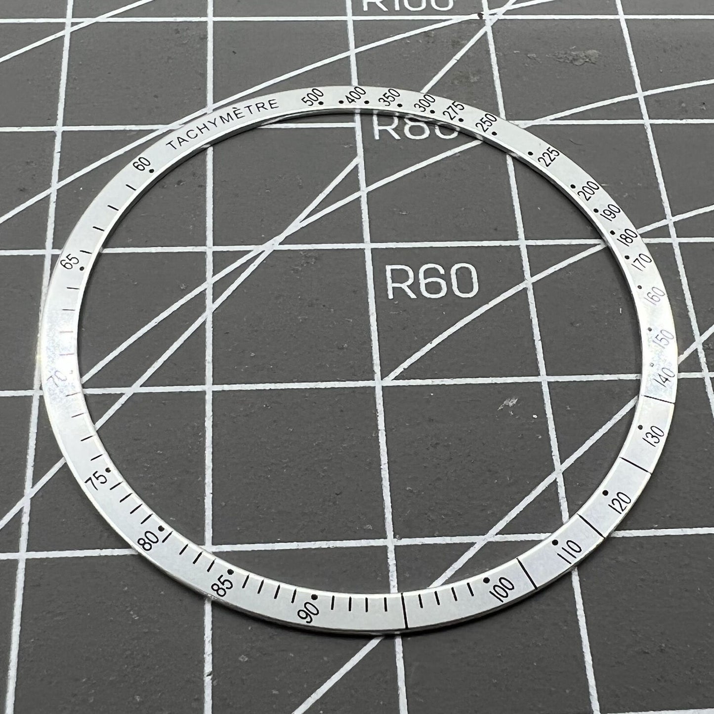 38.5mm Omega Speedmaster aluminum alloy white ring bezel with black font detail for watch customization.
