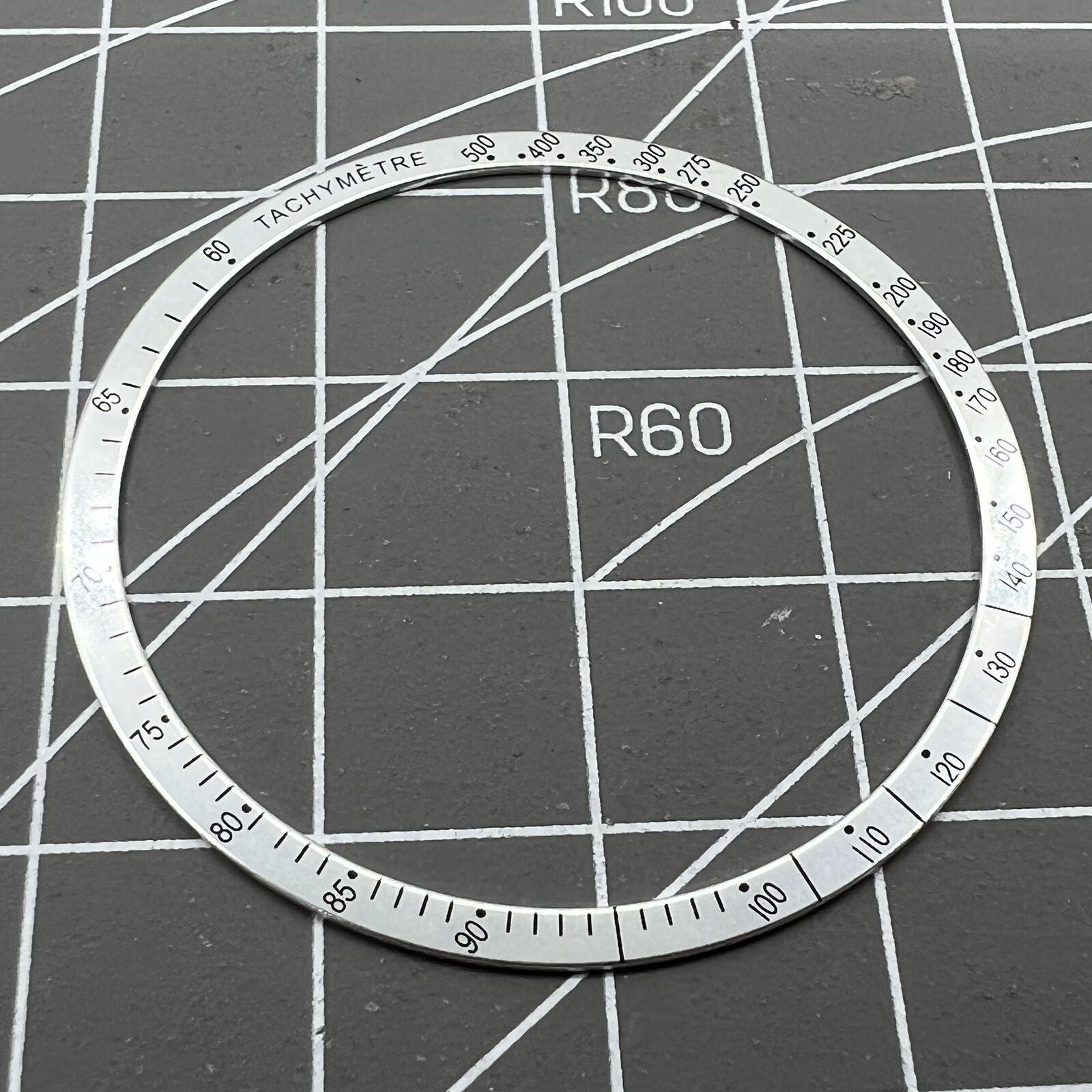 38.5mm Omega Speedmaster aluminum alloy white ring bezel with black font detail for watch customization.