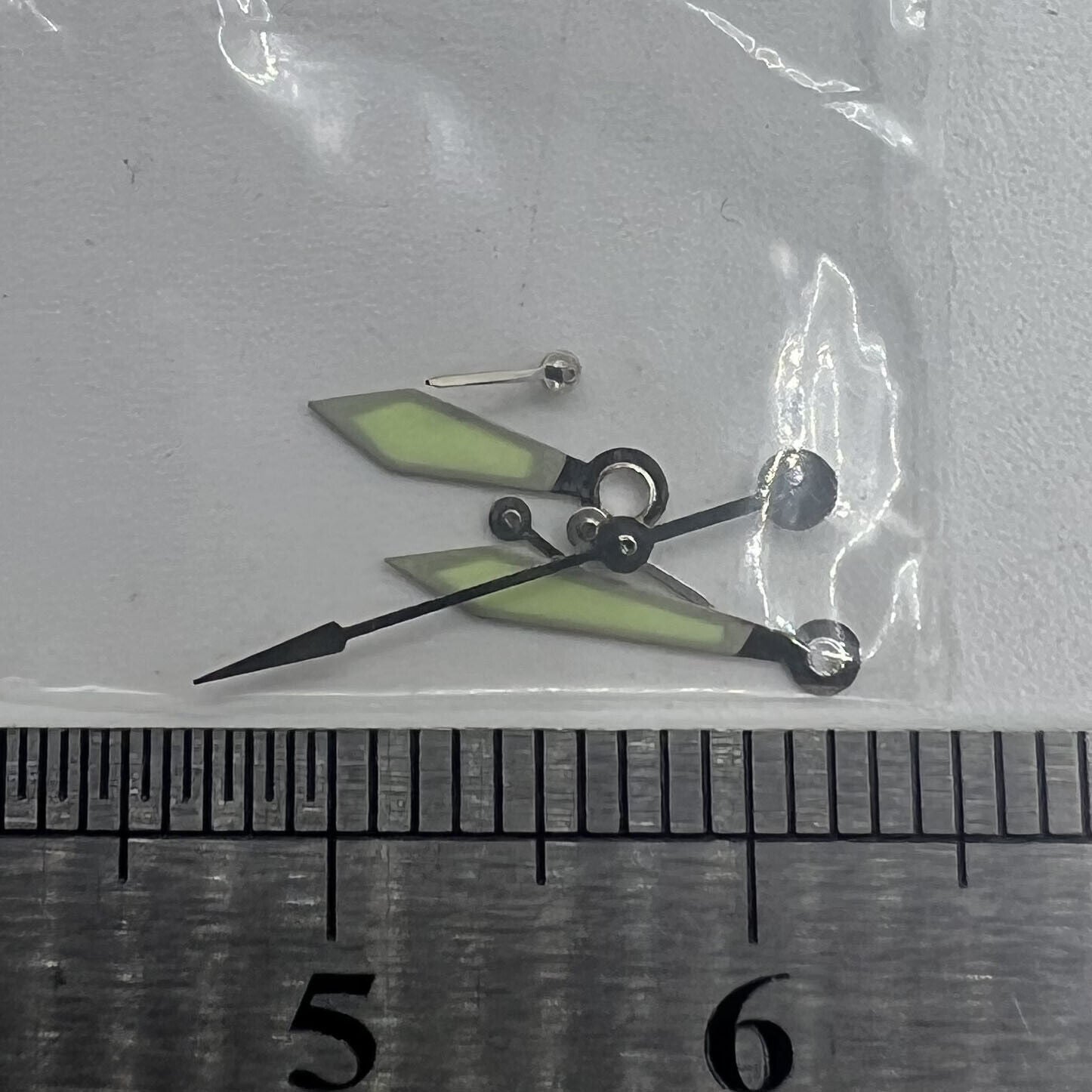 Silver-trimmed 11mm green luminous watch hands by Miyota, perfect for clear time reading on 0S20 models.