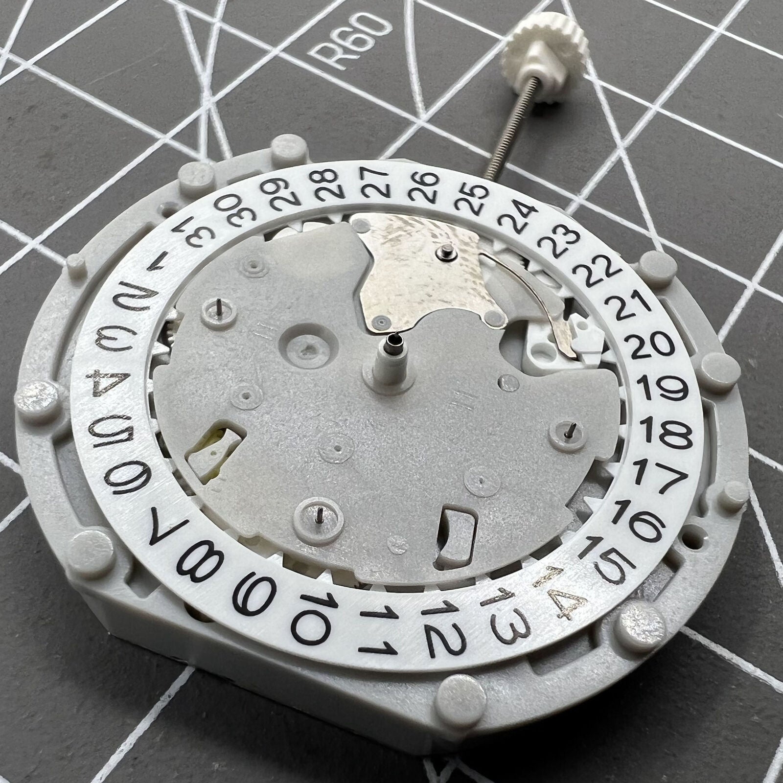 Sunon PE70 watch movement with date at 3 o'clock, three hands, and three subdials at 6, 9, and 12 positions