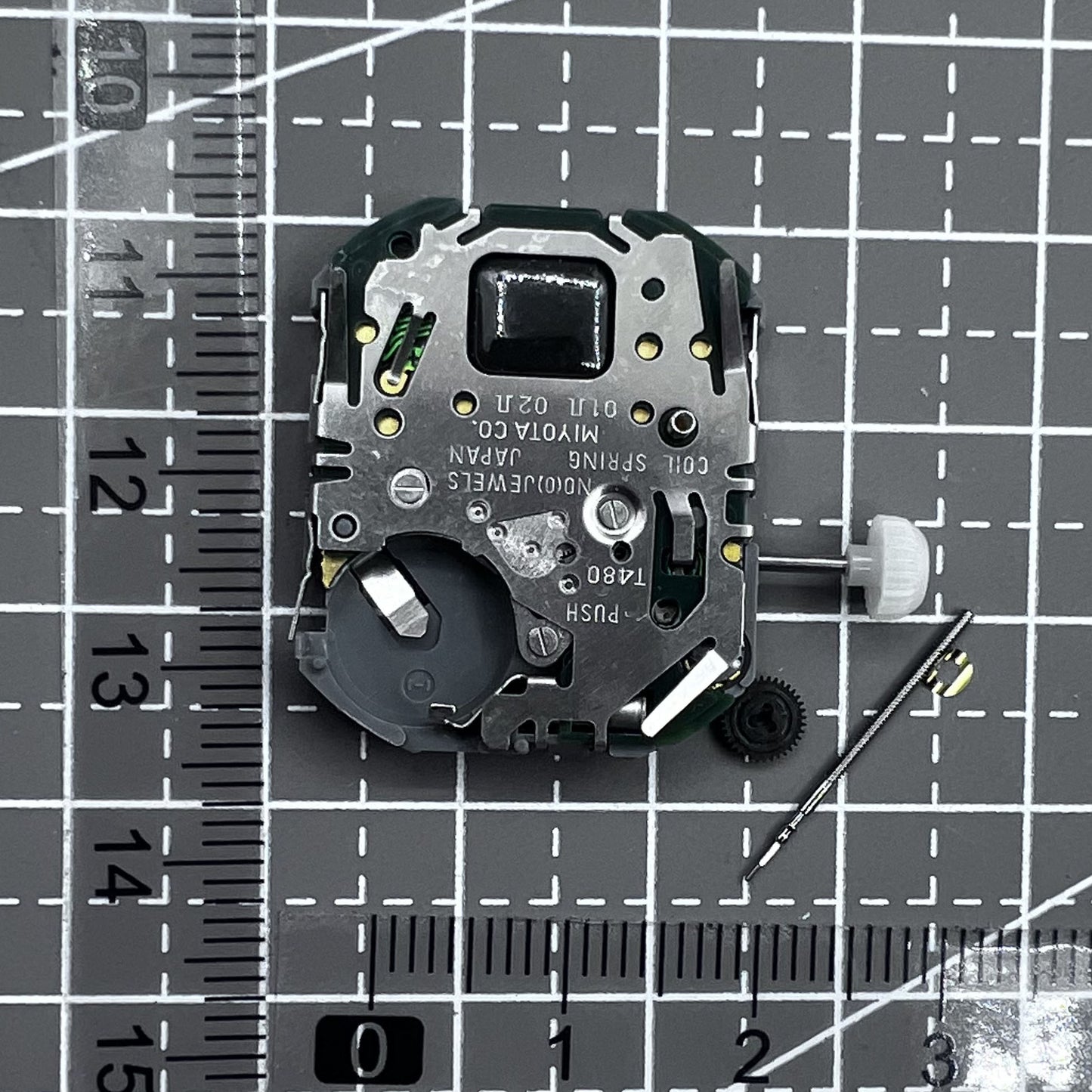 Japan Miyota T480 quartz movement watch mechanism with 3 hands and display screen for precise timekeeping.