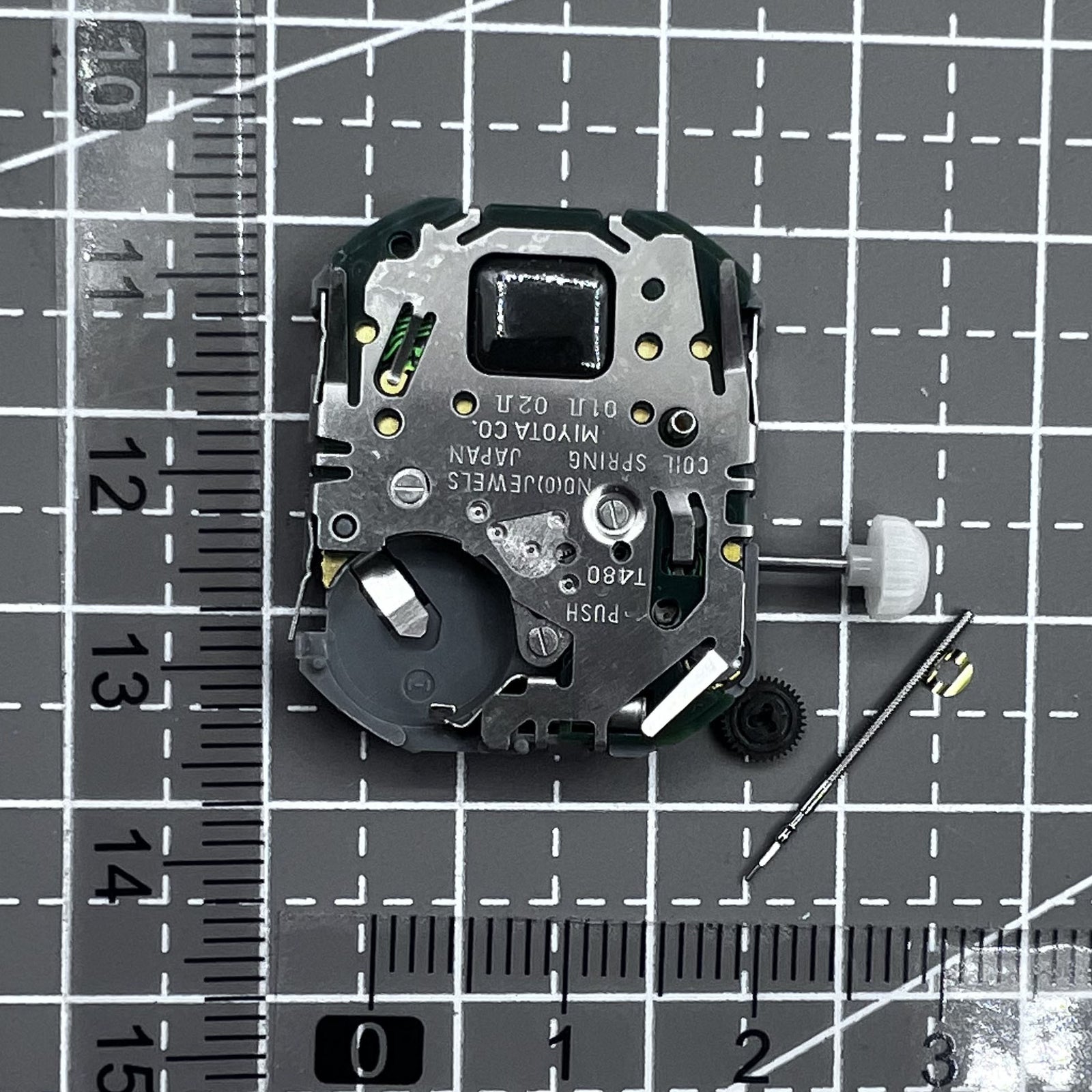 Japan Miyota T480 quartz movement watch mechanism with 3 hands and display screen for precise timekeeping.
