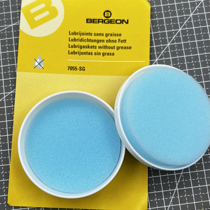 Swiss Bergeon 7055-SG watch lubricant seals box with two silicone grease foam pads for accessories.