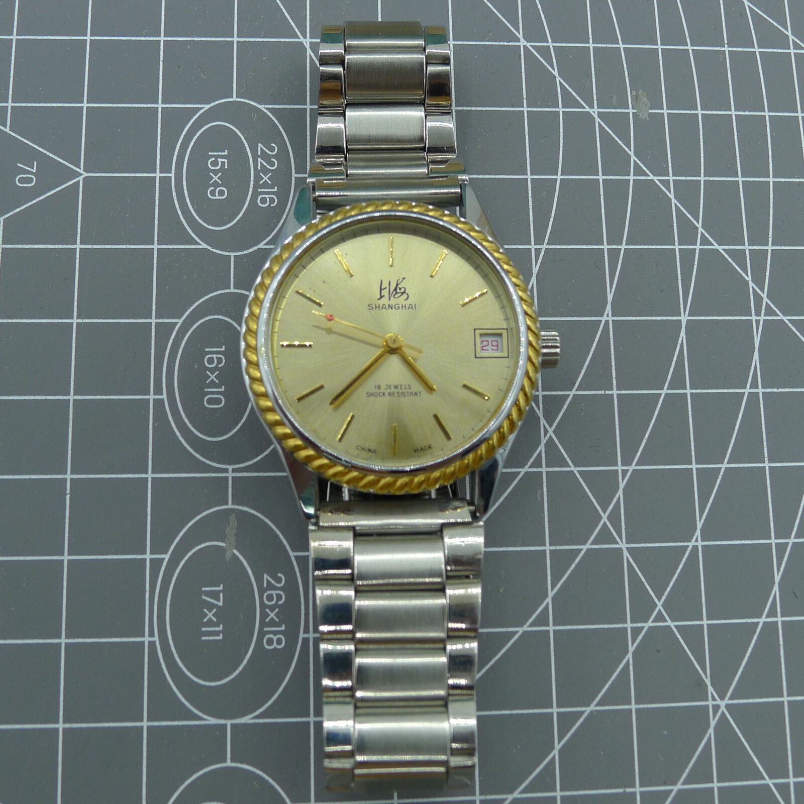 Shanghai Factory 36.5mm manual mechanical watch with 19 jewels, shock-resistant design for durability.