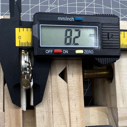 DANDONG 26.5mm hollow silver automatic watch movement highlighting detailed gears and mechanical precision.