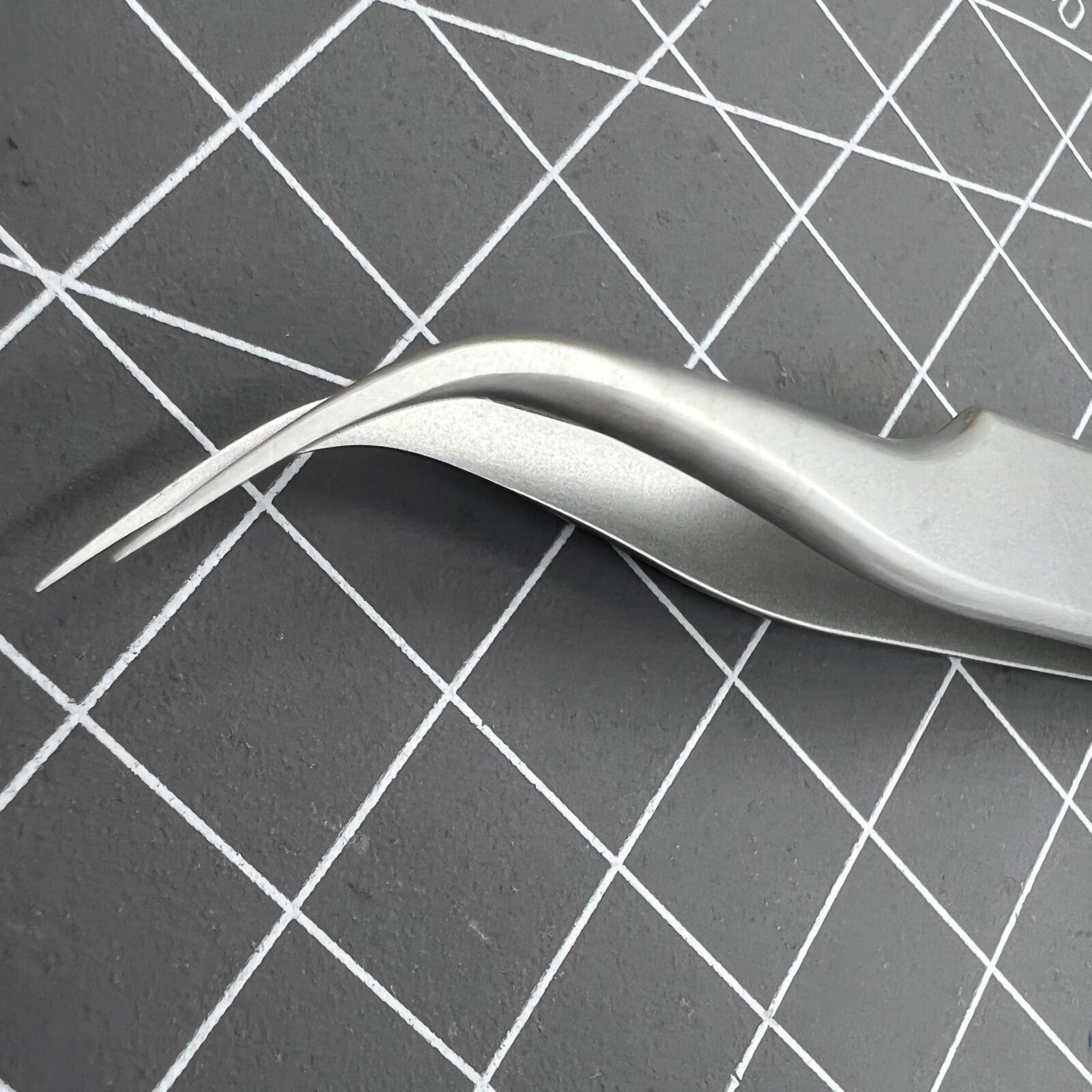 Swiss Bergeon 7026-7 antimagnetic tweezer with fine curved tips for precise watch accessory adjustments.