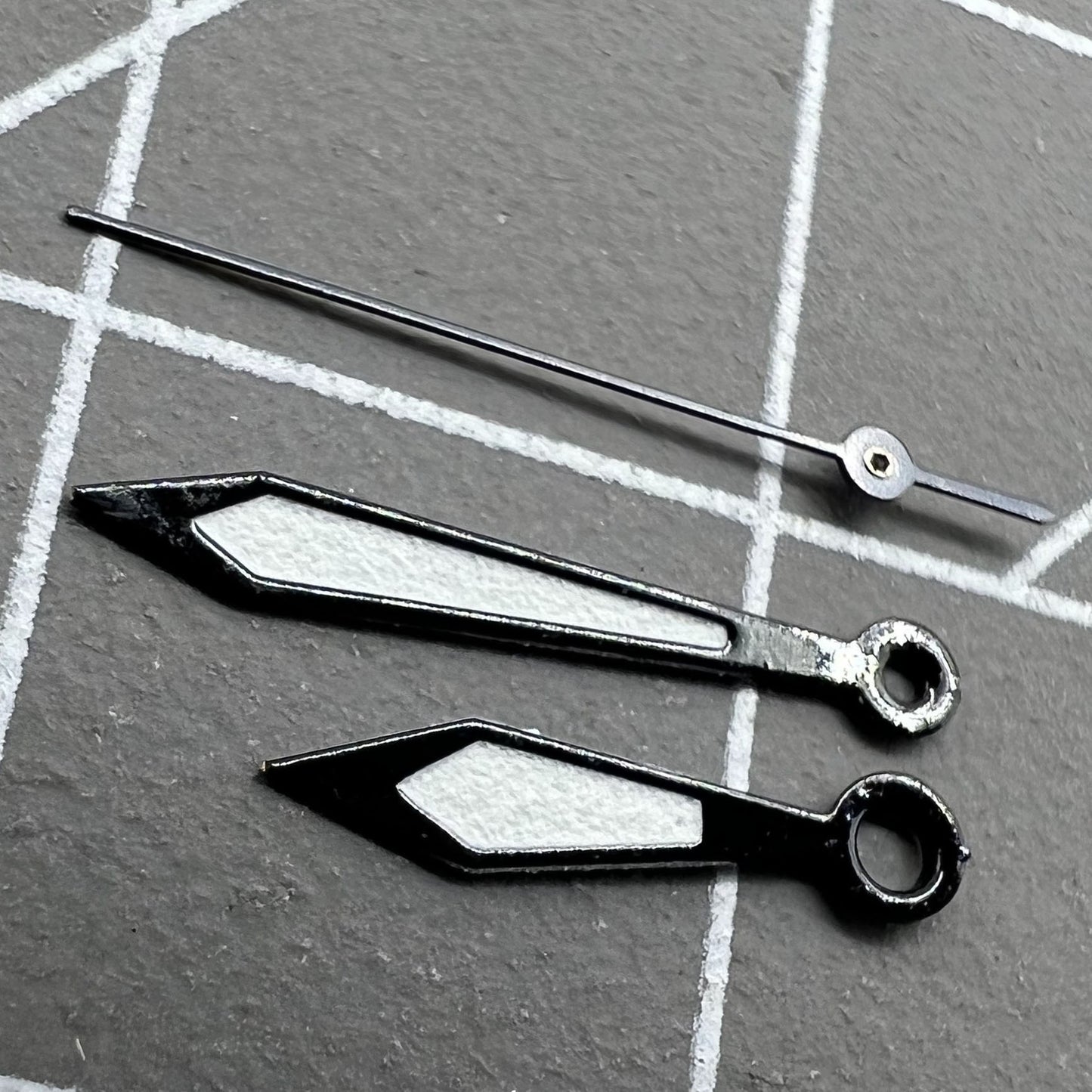 Two sets of 12mm black-trimmed white watch hands for Ronda 515 quartz watches.