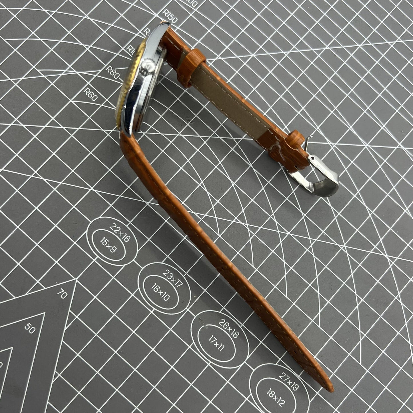 TAIHANG 38mm manual mechanical watch with golden markers, silver dial, round case, and 17 jewels for precision timekeeping.