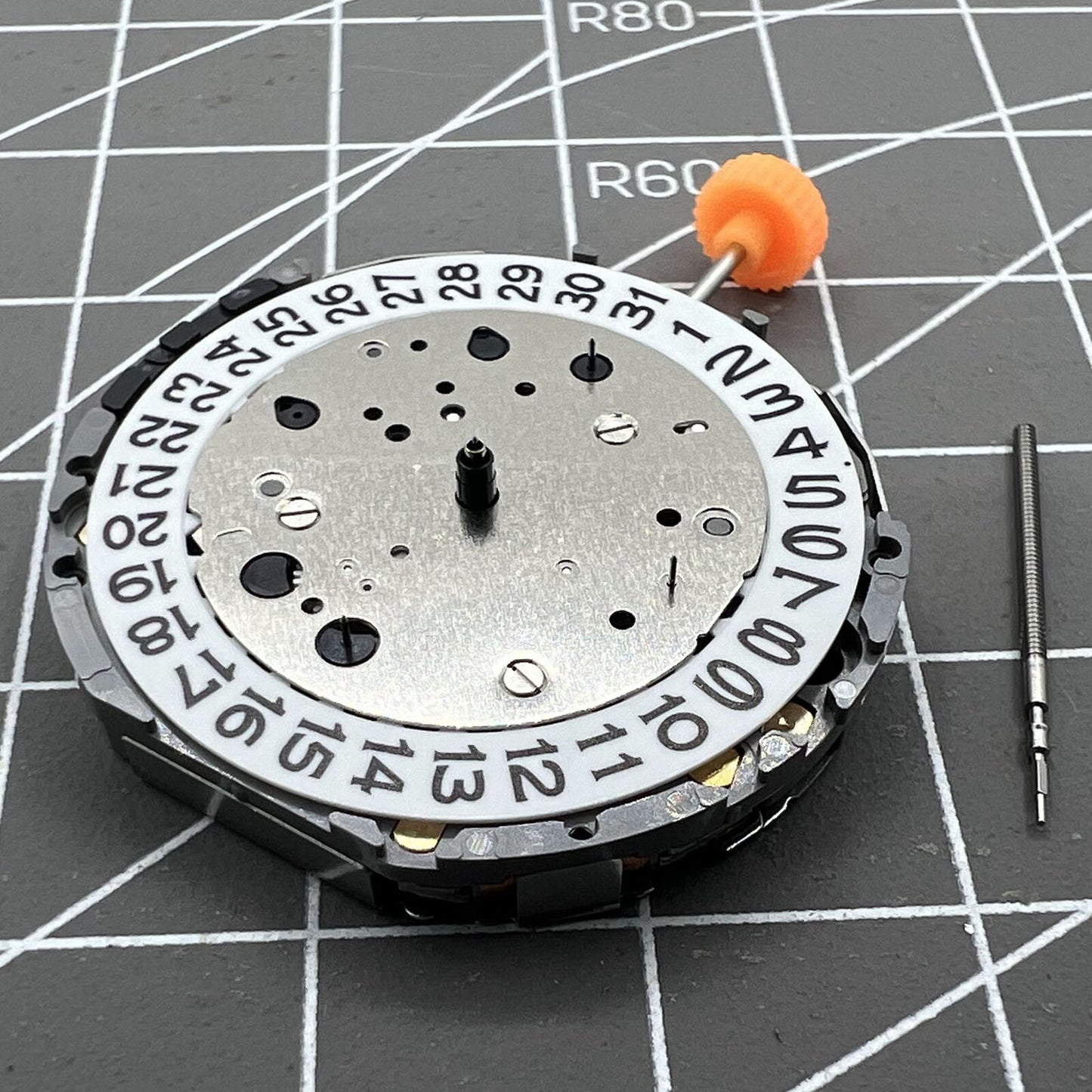 Miyota JS26 quartz watch movement displaying small seconds at 3, 6, 9 and date at 3, Japan-made mechanism.