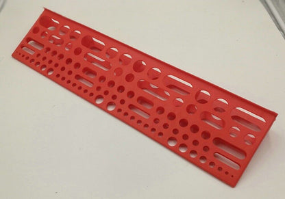 Wall-mounted tool board organizing screwdrivers and pliers for efficient workshop storage.