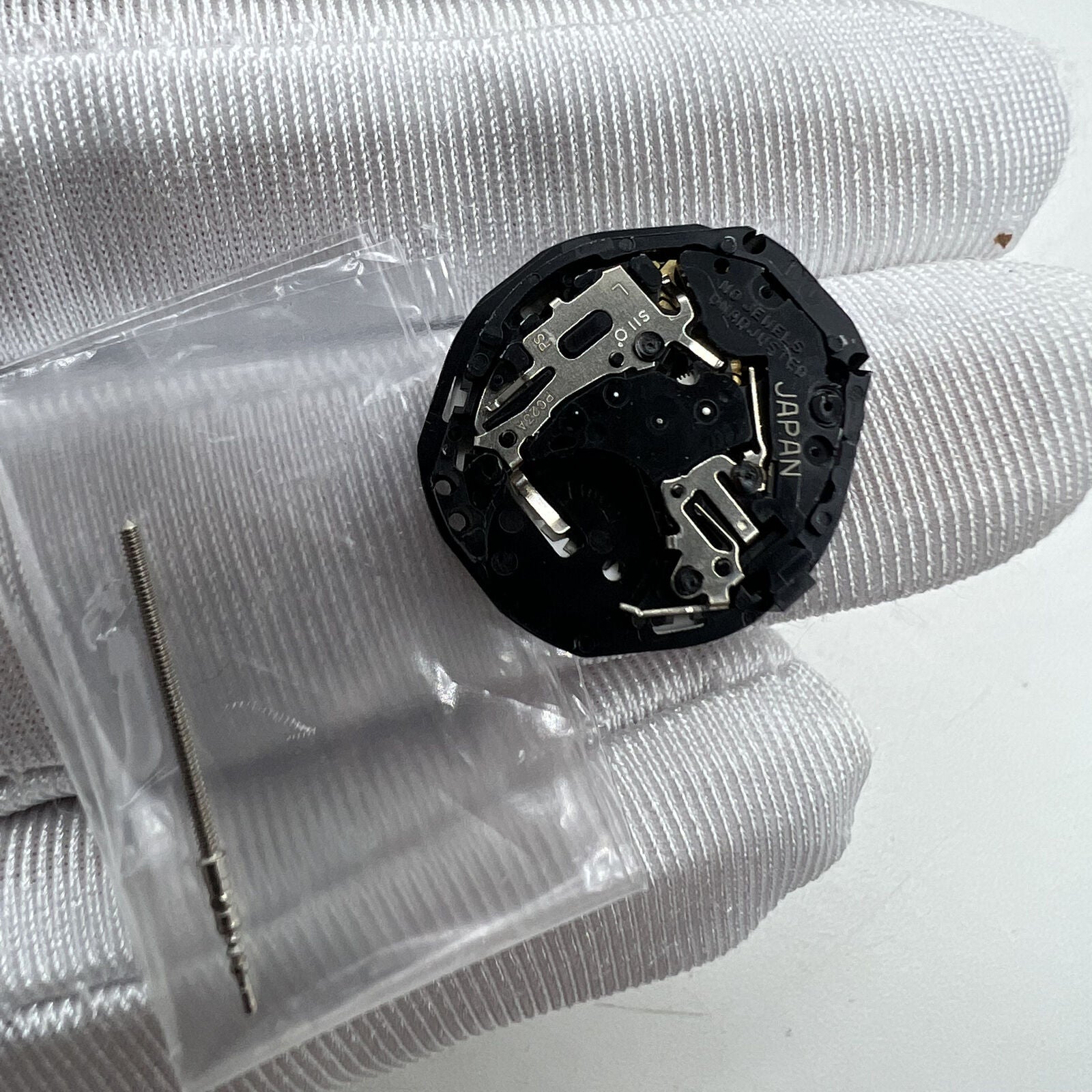 Japan Made Hattori Epson TMI PC23 quartz watch movement, precise and reliable timekeeping component for watch repairs.