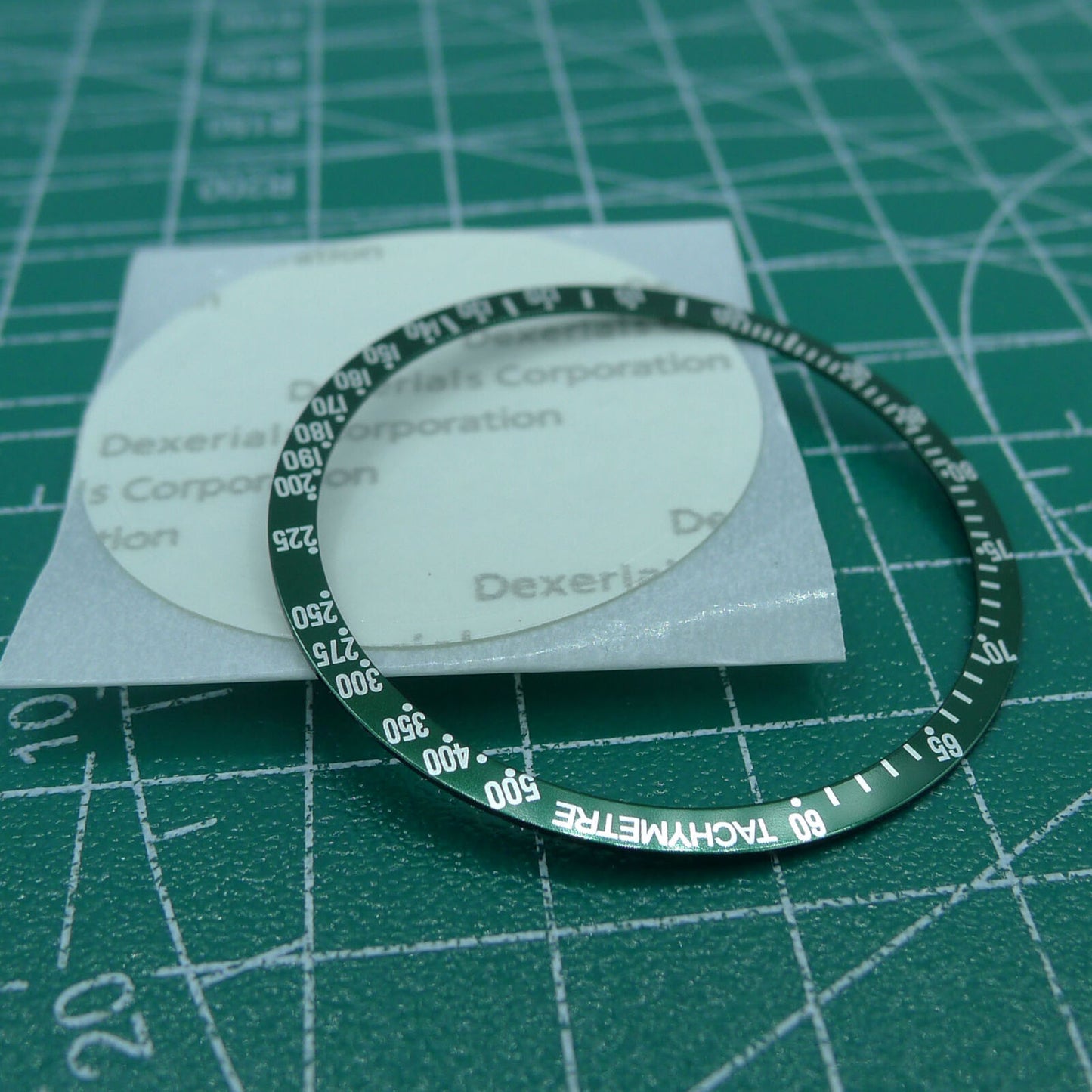 38.5mm green aluminum bezel with white font for Omega Speedmaster, enhancing watch durability and style.