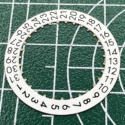 Wholesale lot of OM Font date wheels for ETA 2824 watches, showing date at 3 o?clock position.