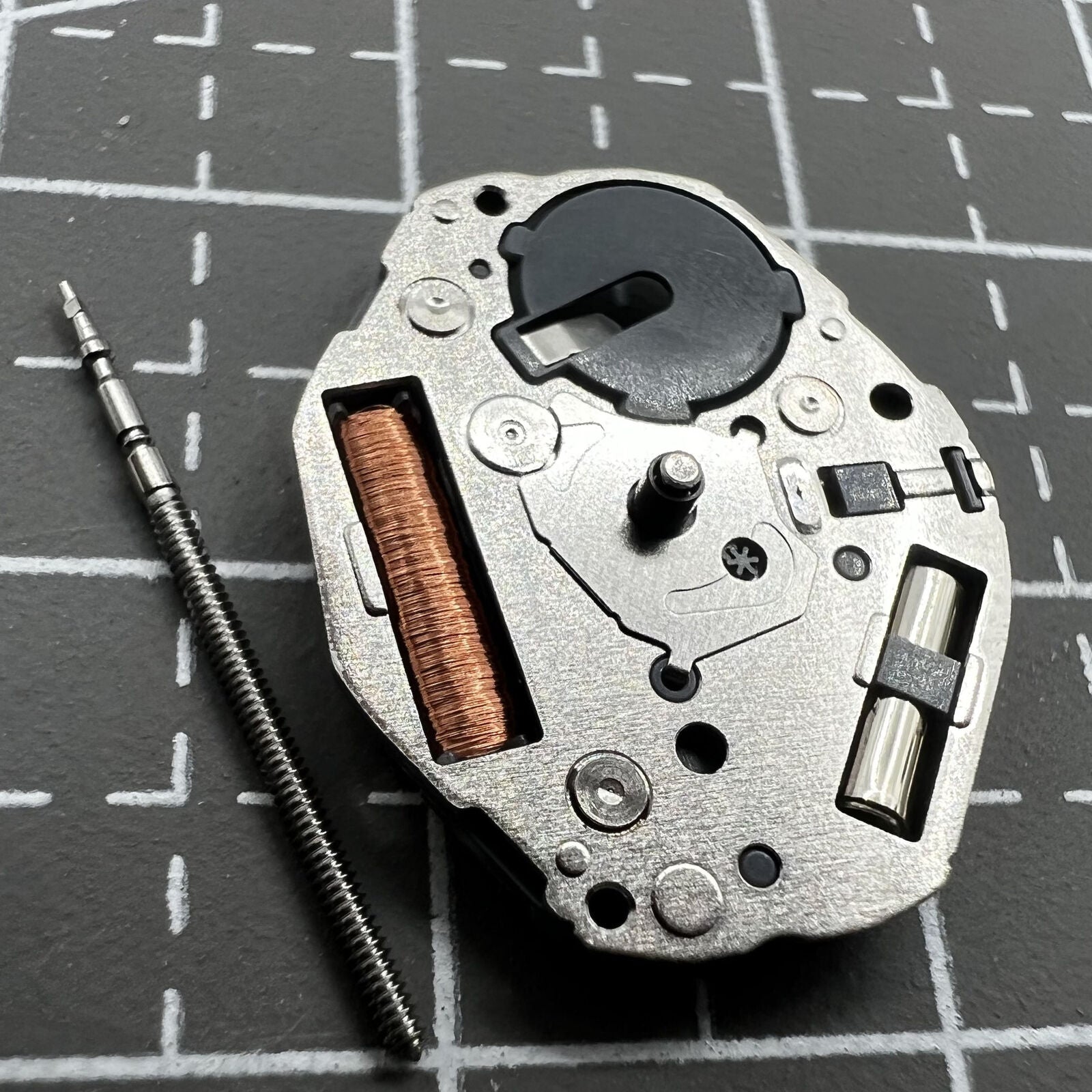 Miyota GL24 silver quartz movement with 2 hands, precise timekeeping for watch repair.