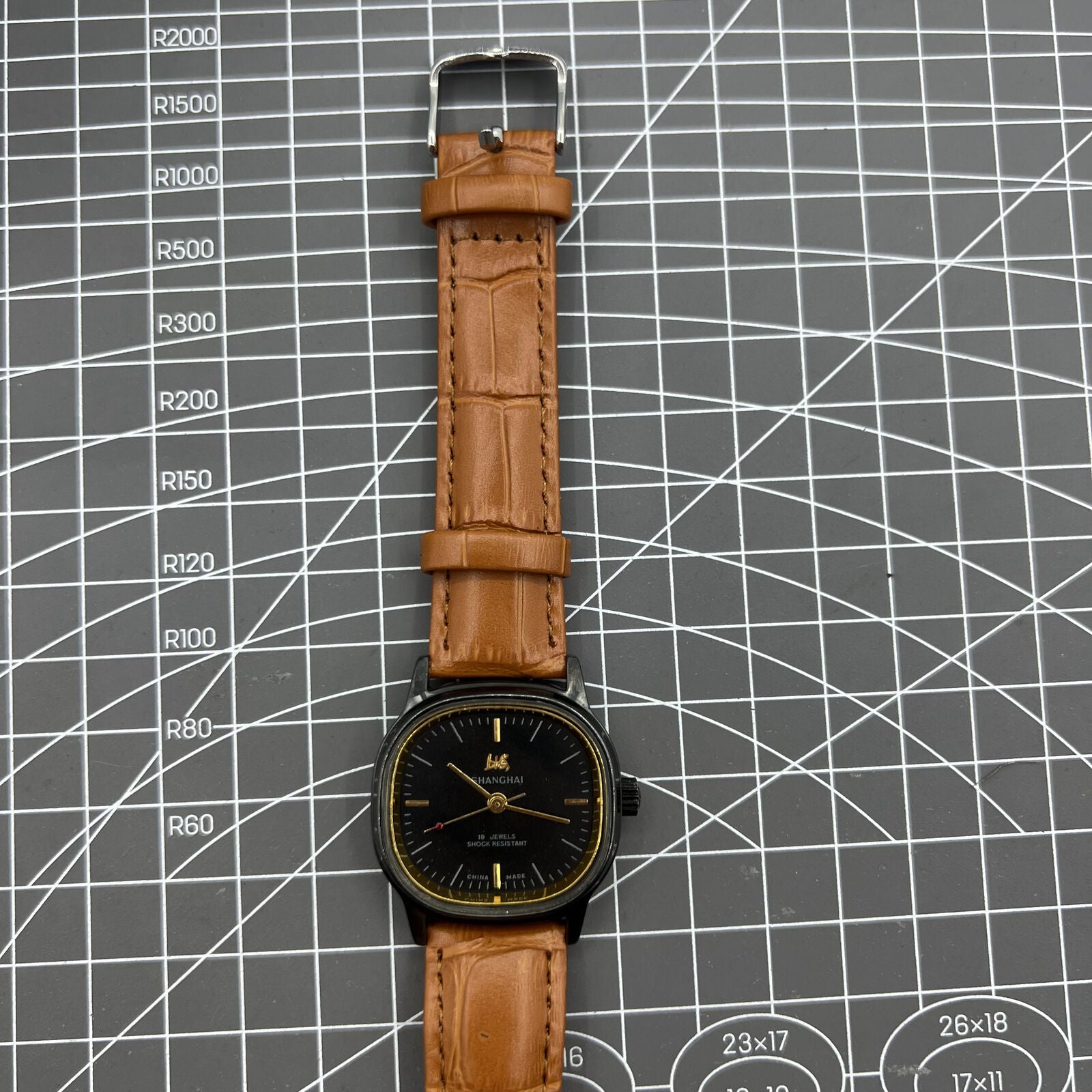 34mm Shanghai Factory manual mechanical watch with black dial, 19 jewels, shock-resistant design.