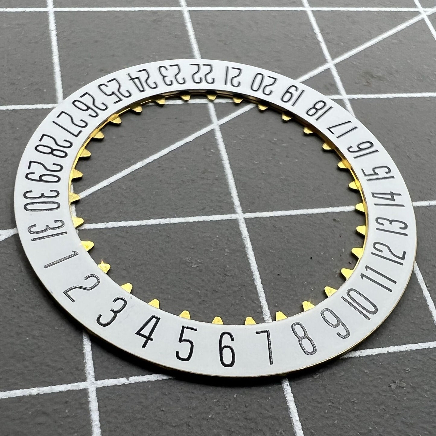 White date disk wheel showcasing original ETA 7750 movement component for precise watch date function.