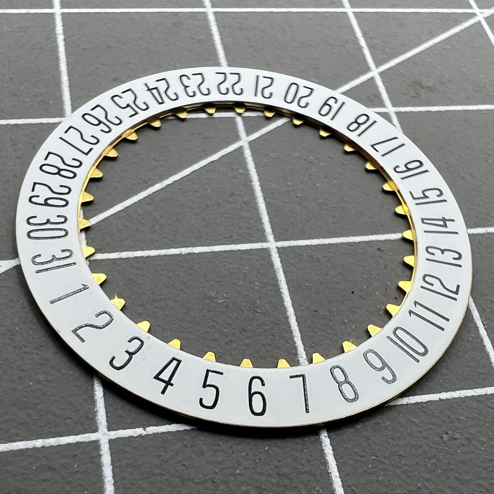 White date disk wheel showcasing original ETA 7750 movement component for precise watch date function.