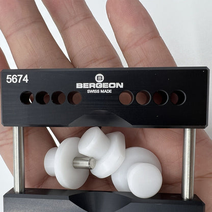 Bergeon 5674 watch vise jaws holding watch case securely for precise repair with 5700-Z tool.