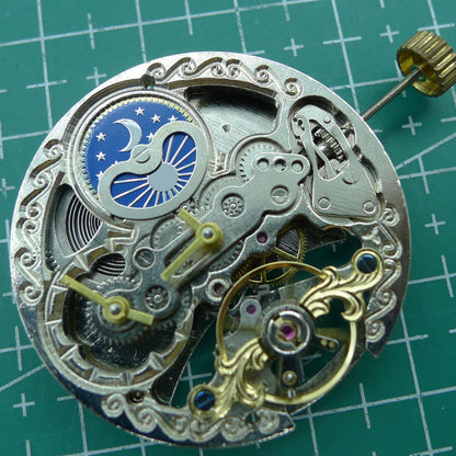 Silver automatic mechanical watch with hollow moon phase at 12 o'clock