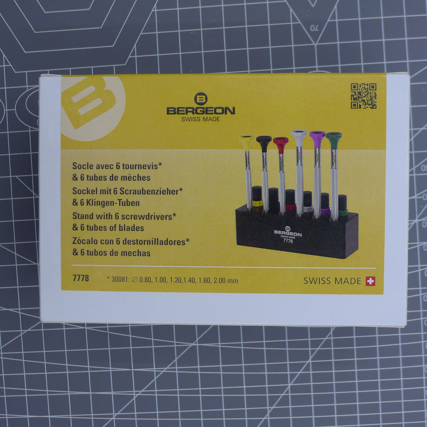 Swiss Bergeon 7778 watch screwdriver set with 6 precision blades, spare tips, and organizer stand for watch repair.