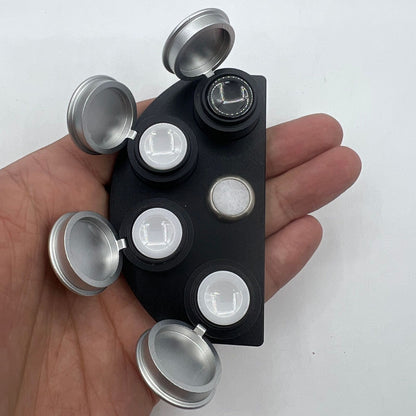 Die-cast alloy oil cup stand holding 4 black ceramic containers for organizing watch accessories.