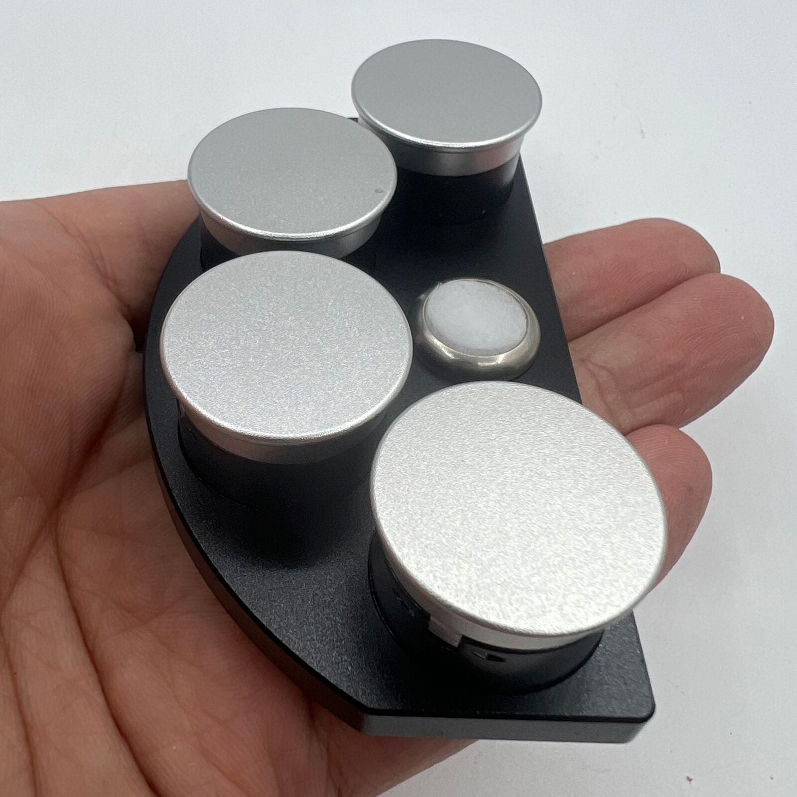 Die-cast alloy oil cup stand with 4 black ceramic containers for organized watch accessory storage.