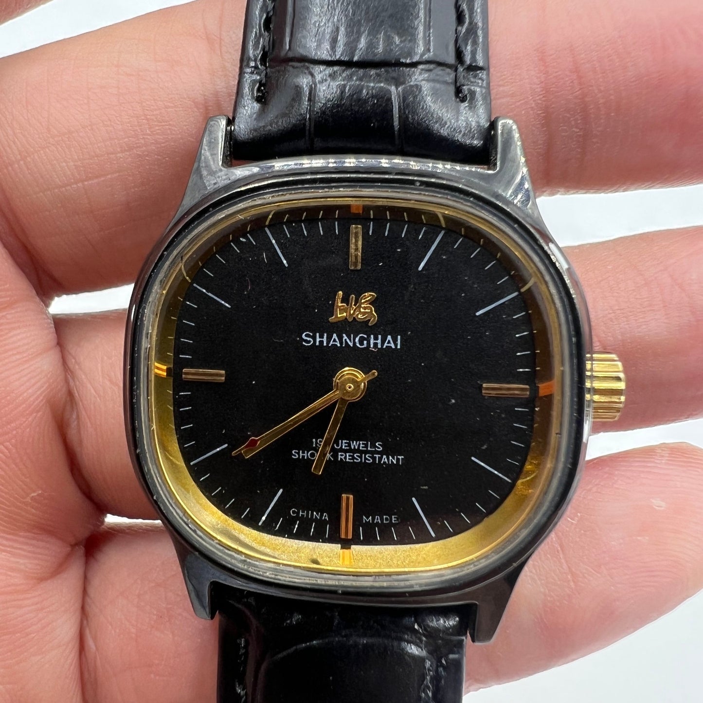 Shanghai Factory 34mm manual mechanical watch with black dial, 19 jewels, shock-resistant, elegant design.