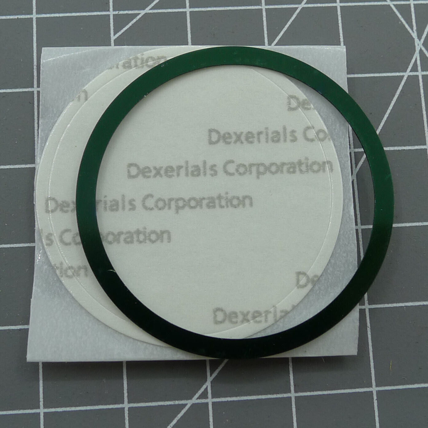 Omega Speedmaster 38.5mm green aluminum bezel with white font, durable watch accessory for stylish timepieces.