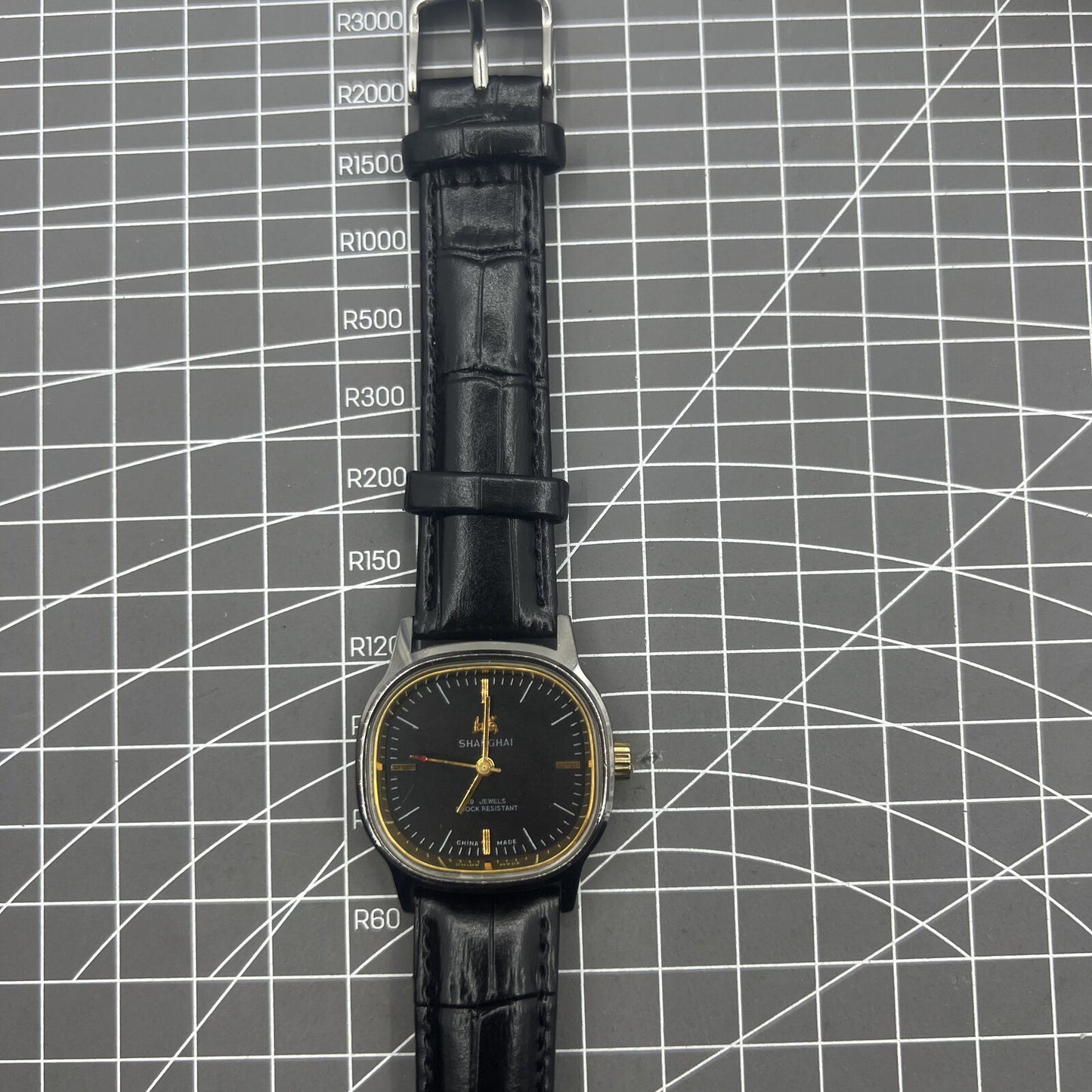 Shanghai Factory 34mm manual mechanical watch with black dial, 19 jewels, and shock-resistant design.