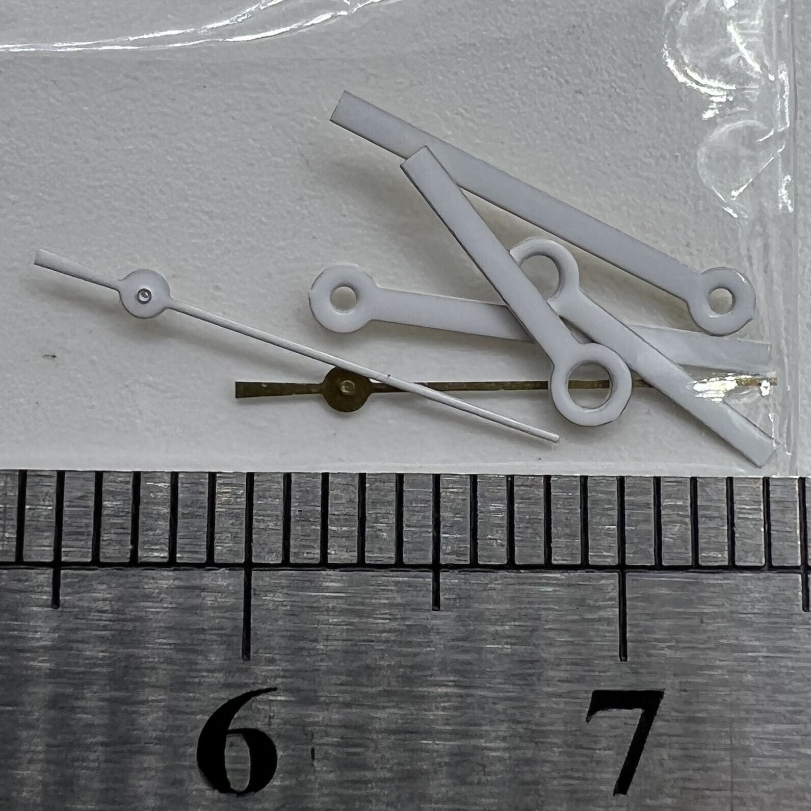 White watch hands set for Miyota 2035 movement, precise fit with 15x13x9mm dimensions, branded quality craftsmanship.