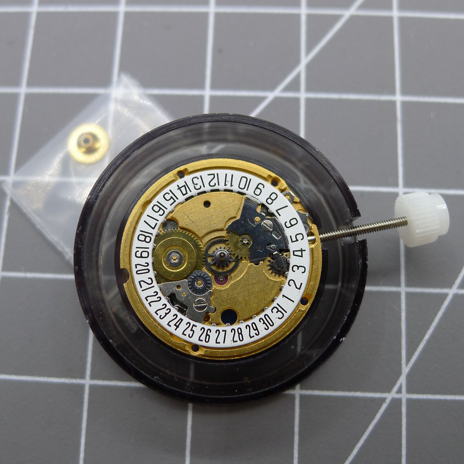 Swiss Made ETA 956.112 quartz watch movement showing 3 hands and date window at 6 o'clock for precise timekeeping.