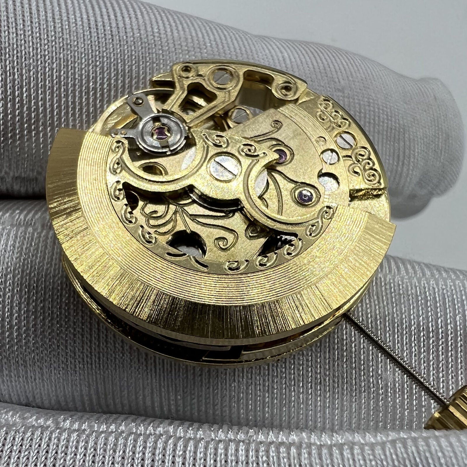 Golden 26.5mm 7120 automatic watch movement with carved hollow design, ideal for watch repairs.