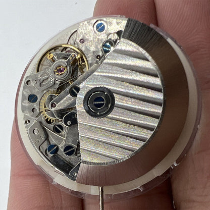Close-up of Asian 7750 automatic chronograph movement with white calendar at 4:30 and seconds subdial at 9, showcasing precision watch components.