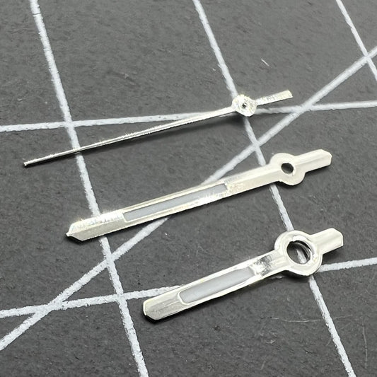 Silver 13mm watch hands with green lume for Hattori Epson PC32 quartz movements, enhancing visibility and style.